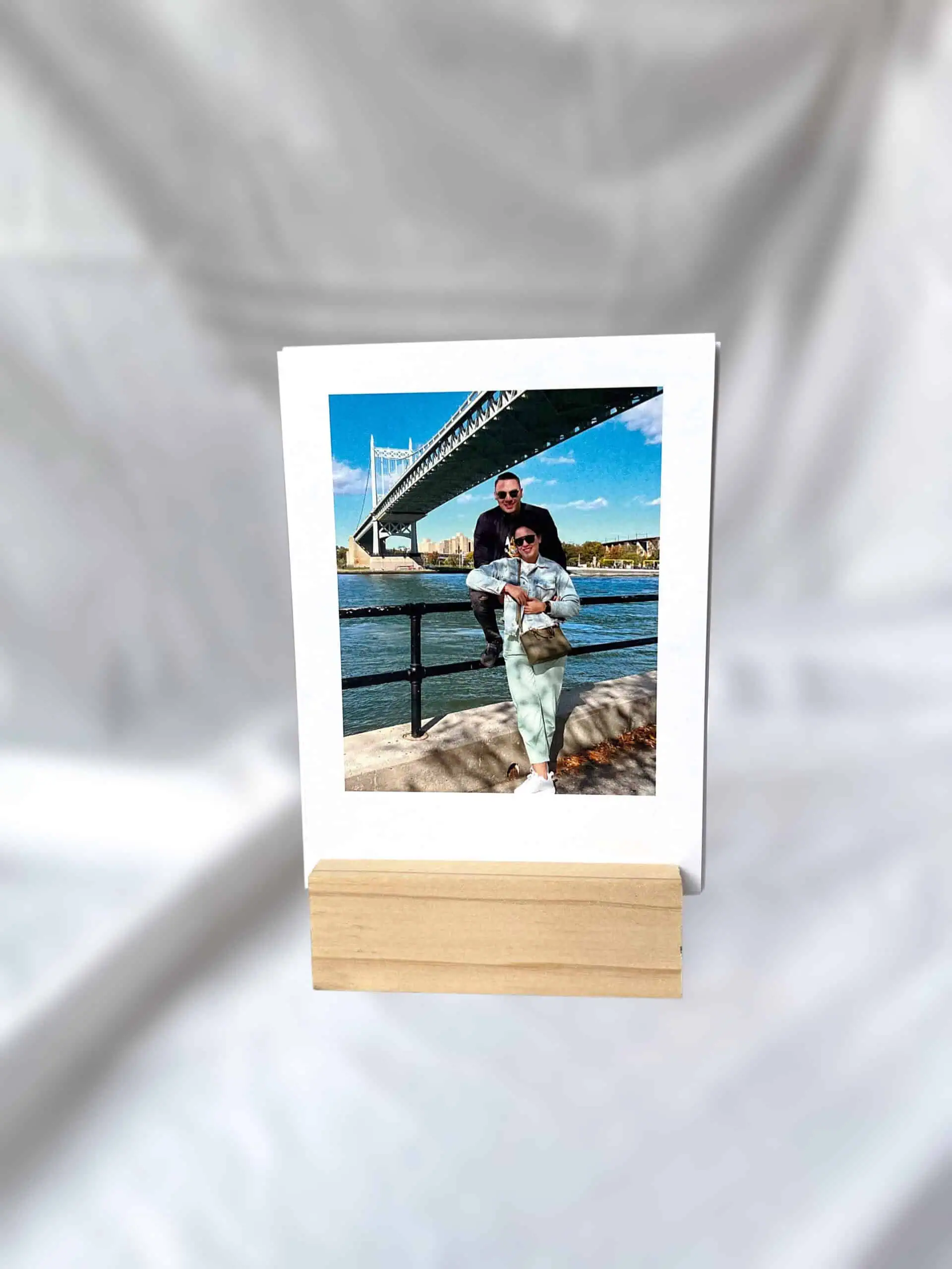 Amantes en paisaje urbano con puente y río en fondo, foto impresa en soporte de madera, para impresión fotográfica personalizada.